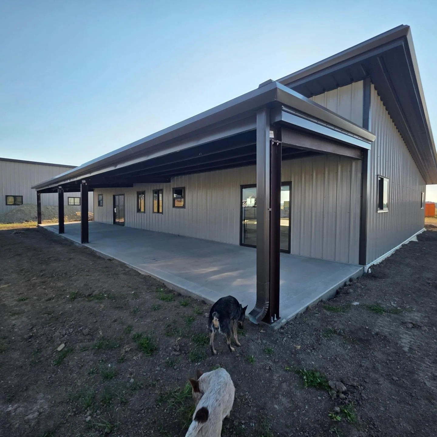 Covered concrete patio tan metal building brown posts