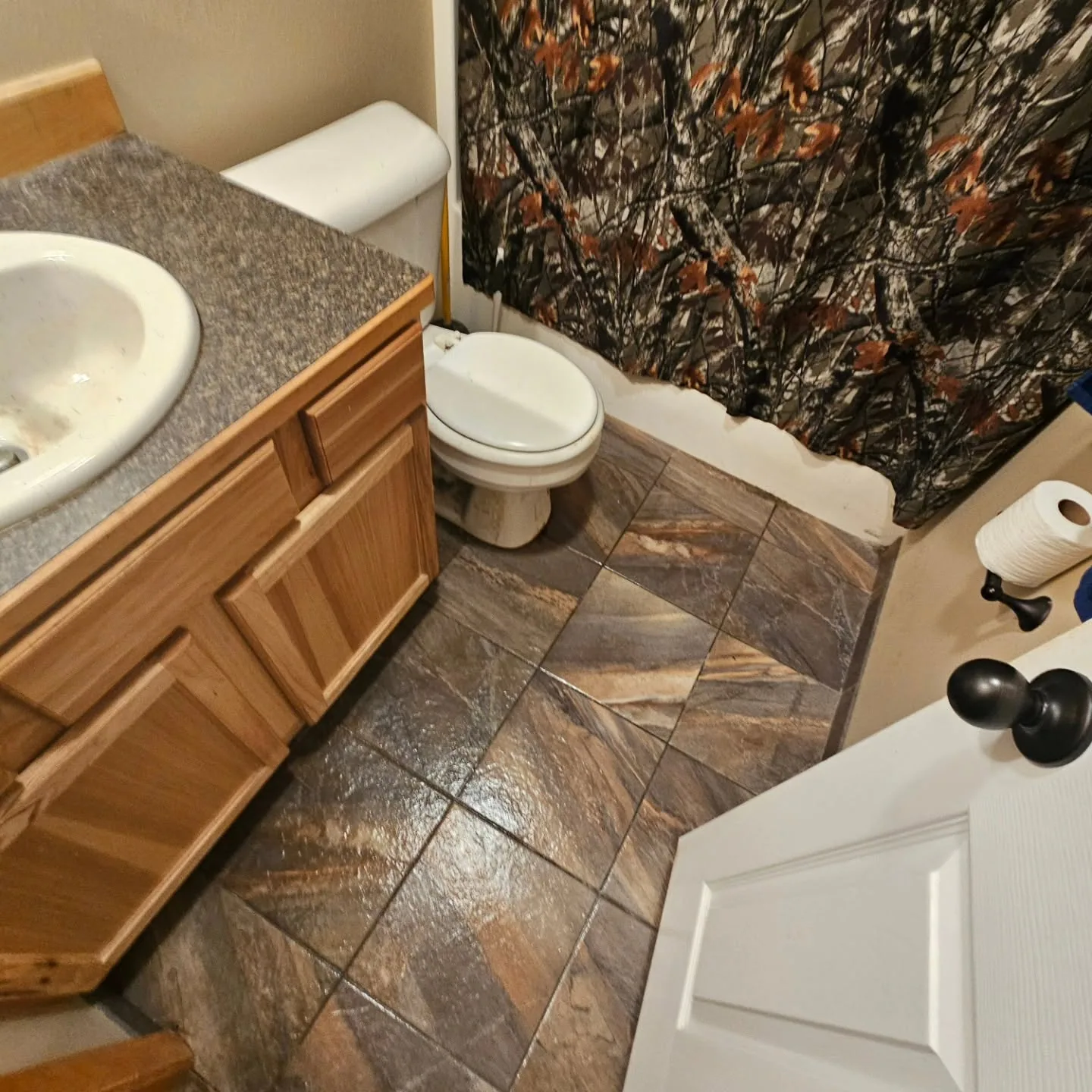 Diagonal stone look tile bathroom floor oak vanity