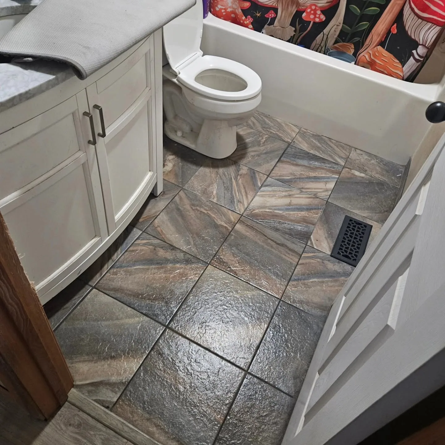 Diagonal stone look tile bathroom floor remodel