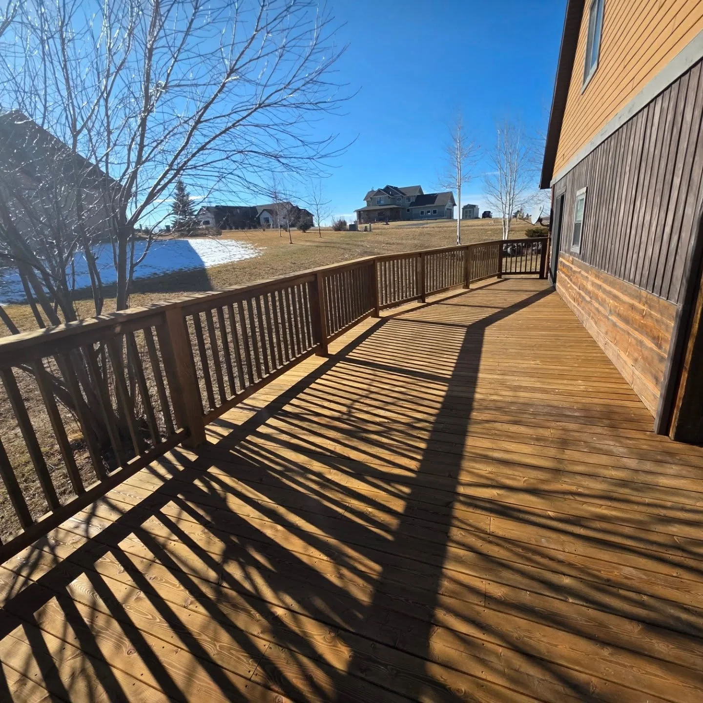 Finished stained wood deck railing baluster shadows