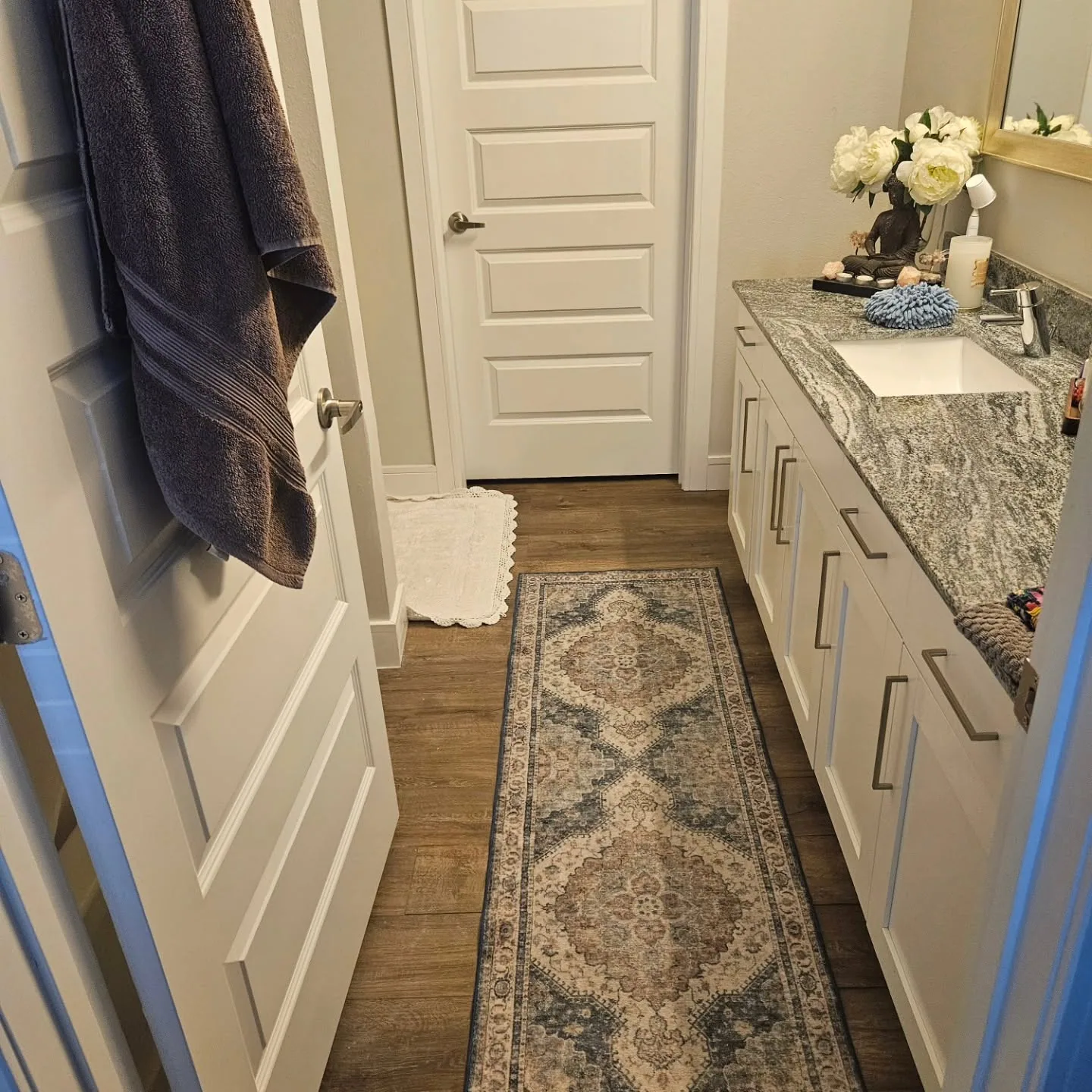 Gray granite vanity white shaker cabinets runner rug