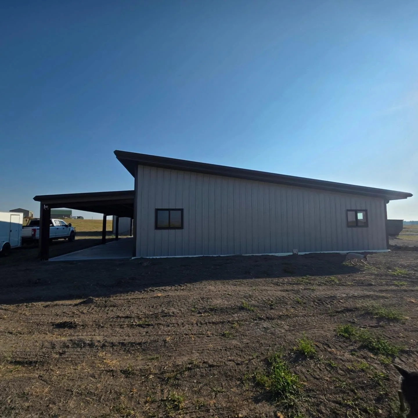 Gray metal shop single slope roof covered lean to