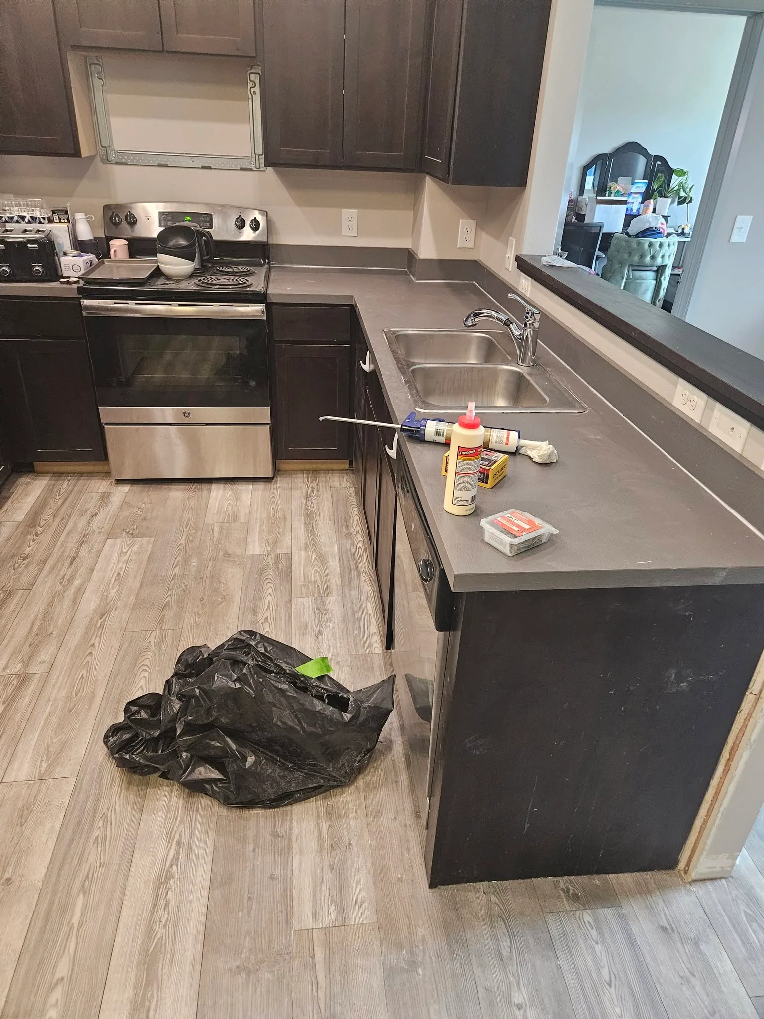 Kitchen countertop repair in progress dark cabinets