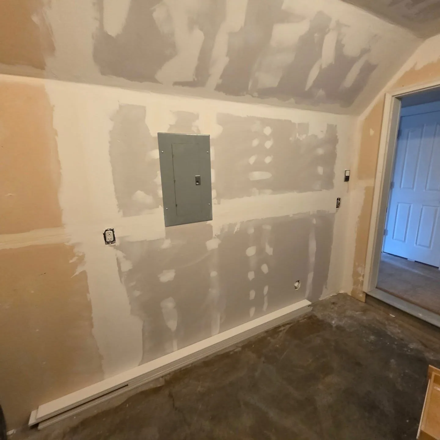 Mudded drywall wall electrical panel sloped ceiling