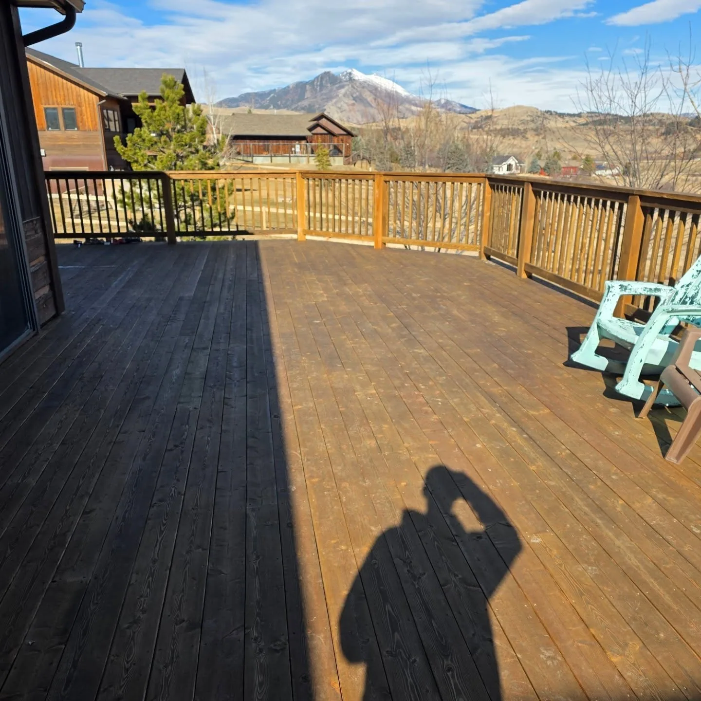 Snowcapped peak view stained deck adirondack chair