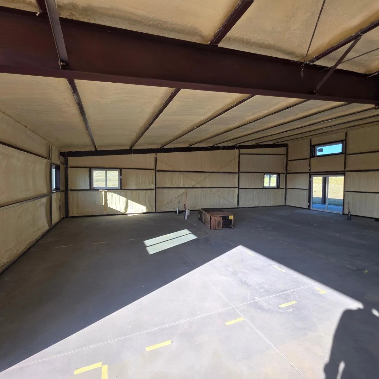 Spray foam insulated steel building interior concrete slab