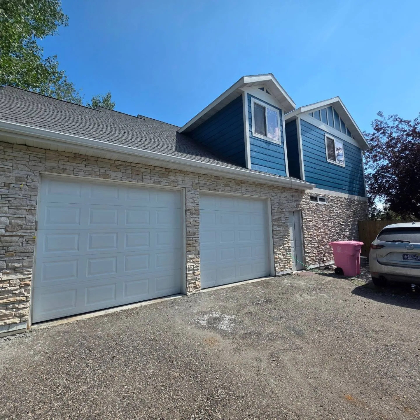 Stone veneer garage blue siding dormers