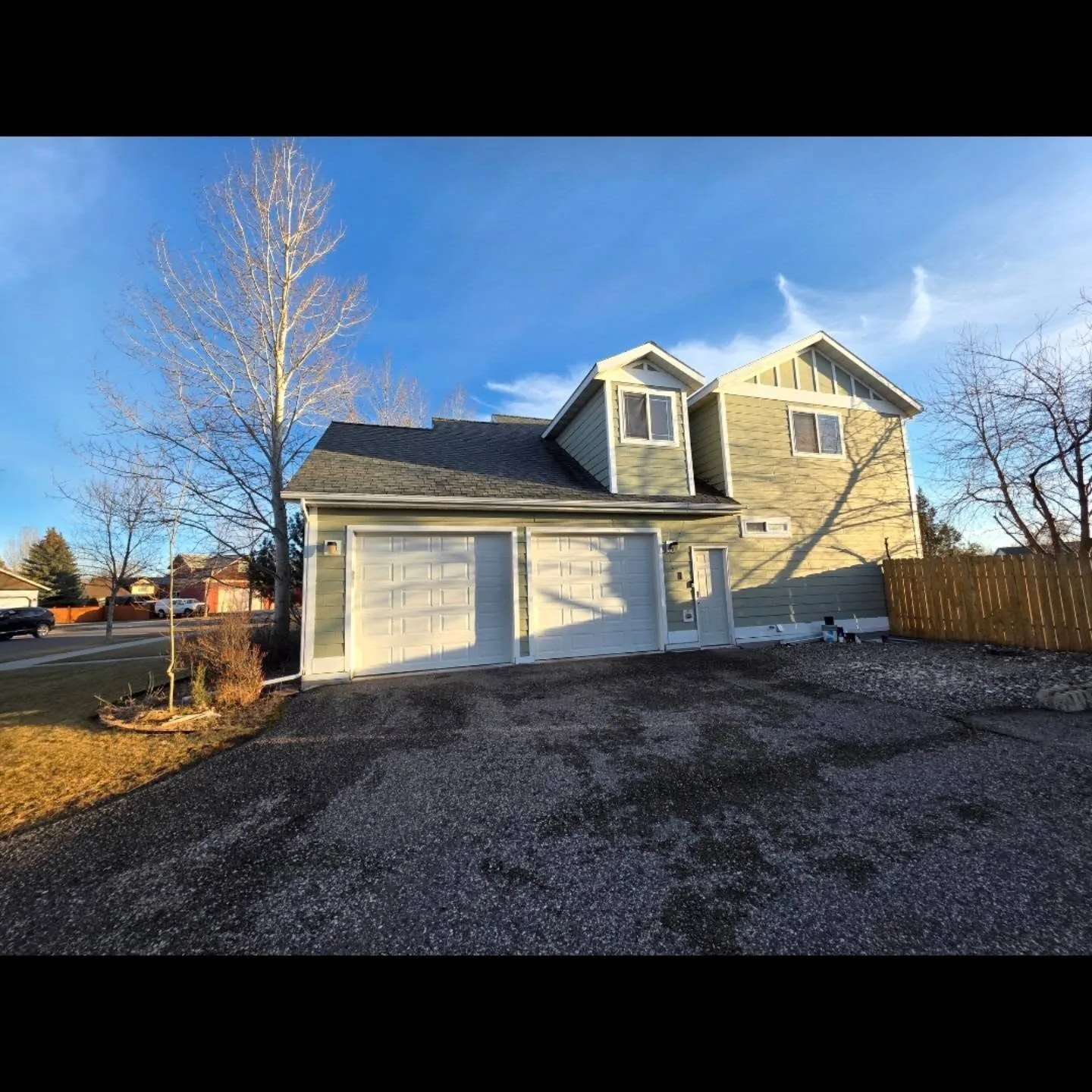 Two car garage dormer addition gravel driveway